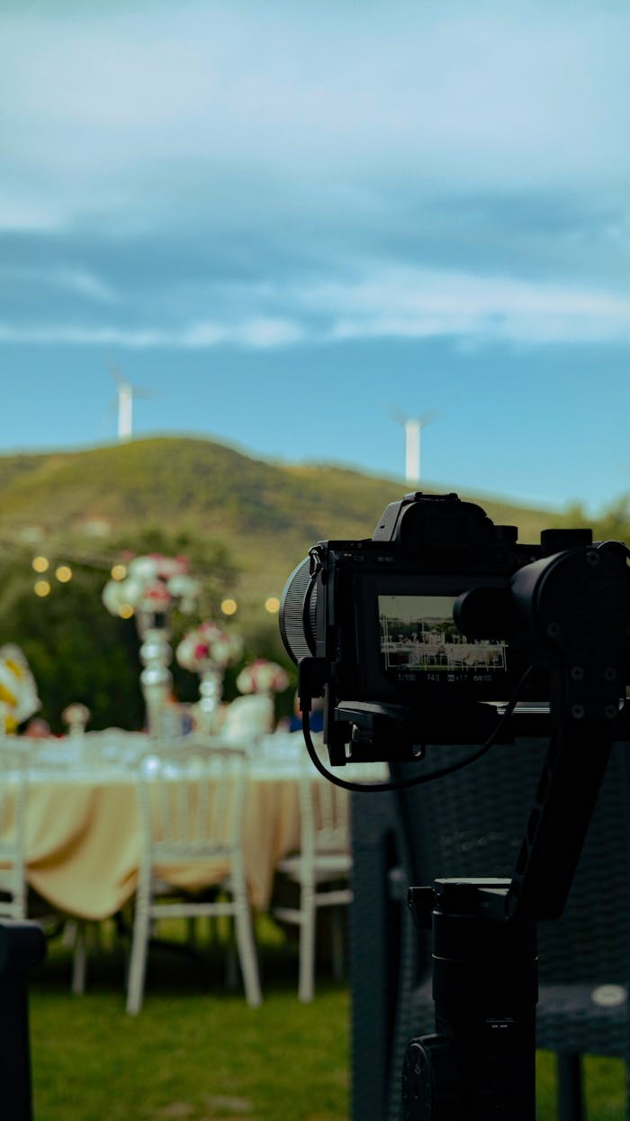 Mastering the First Impression: Your intriguing post title goes here Camera on gimbal filming a beautifully set outdoor banquet table with scenic hills.